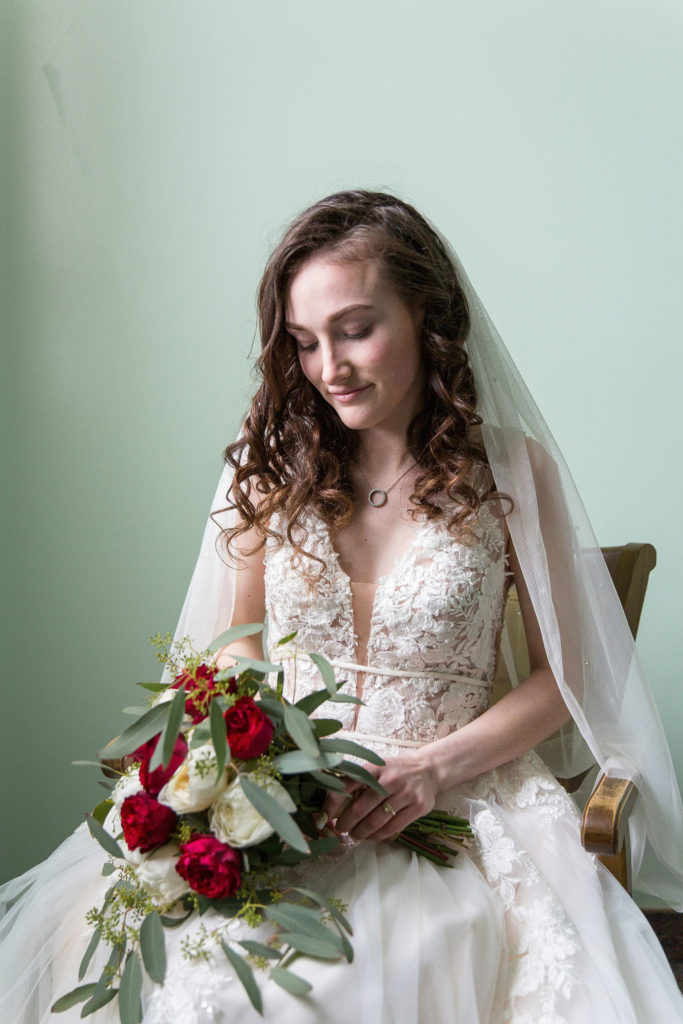 bride puts on her wedding dress at Trinity Missionary Church in Yale, Michigan