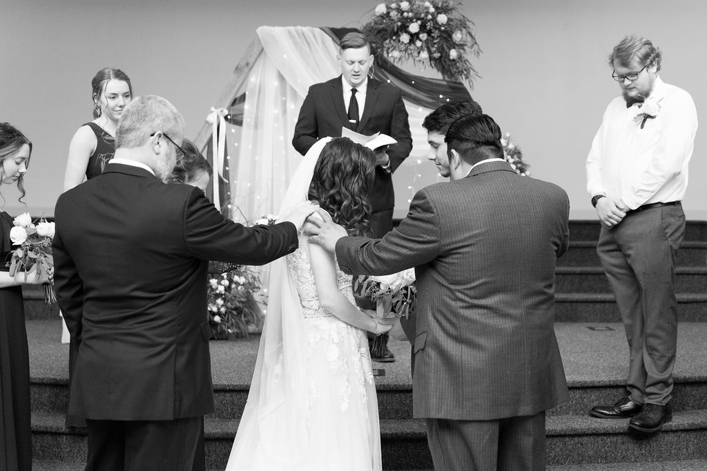 dad walks bride up the aisle during a wedding at Trinity Missionary Church in Yale, Michigan