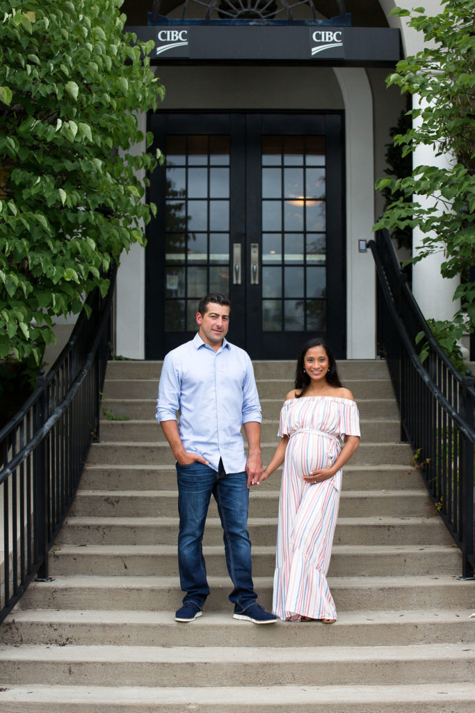Downtown Rochester Michigan Summer Maternity Session couple walking down staircase
