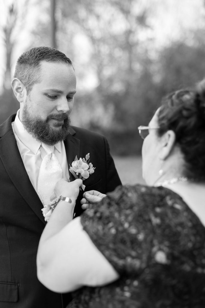 Groom putting on his tux during his Lansing Wedding photographed by Taylor Ingles Photography