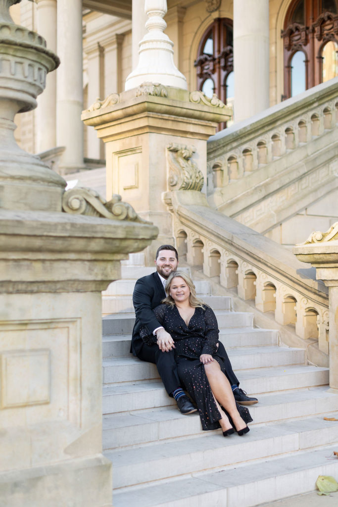 couple sitting on the steps of the Lansing Capitol Building