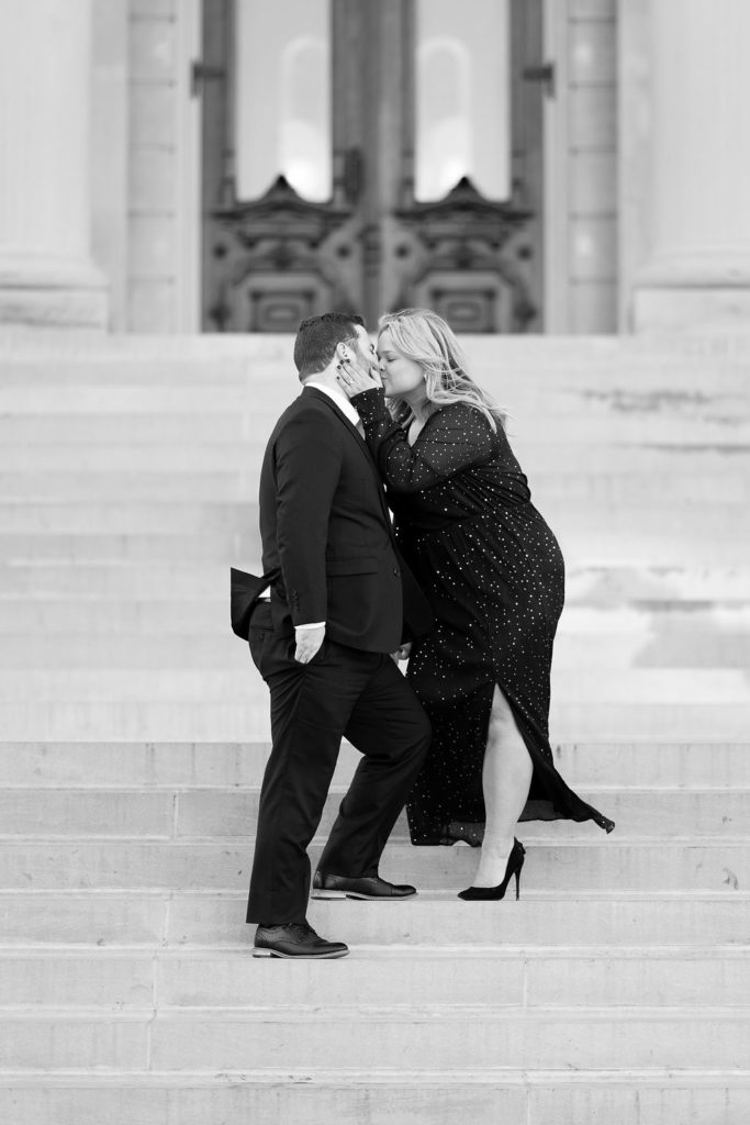 Engaged couple kissing during their black tie engagement session