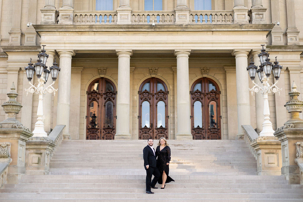 couple standing on the steps of the Lansing Capitol Building