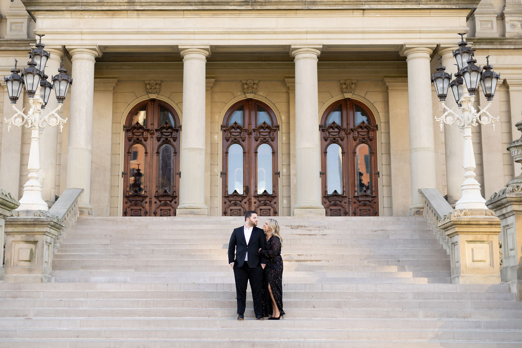 couple standing on the steps of the Lansing Capitol Building