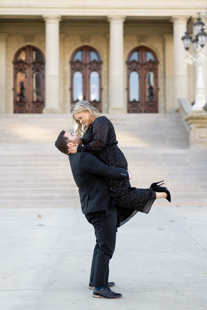 Engaged couple kissing during their black tie engagement session